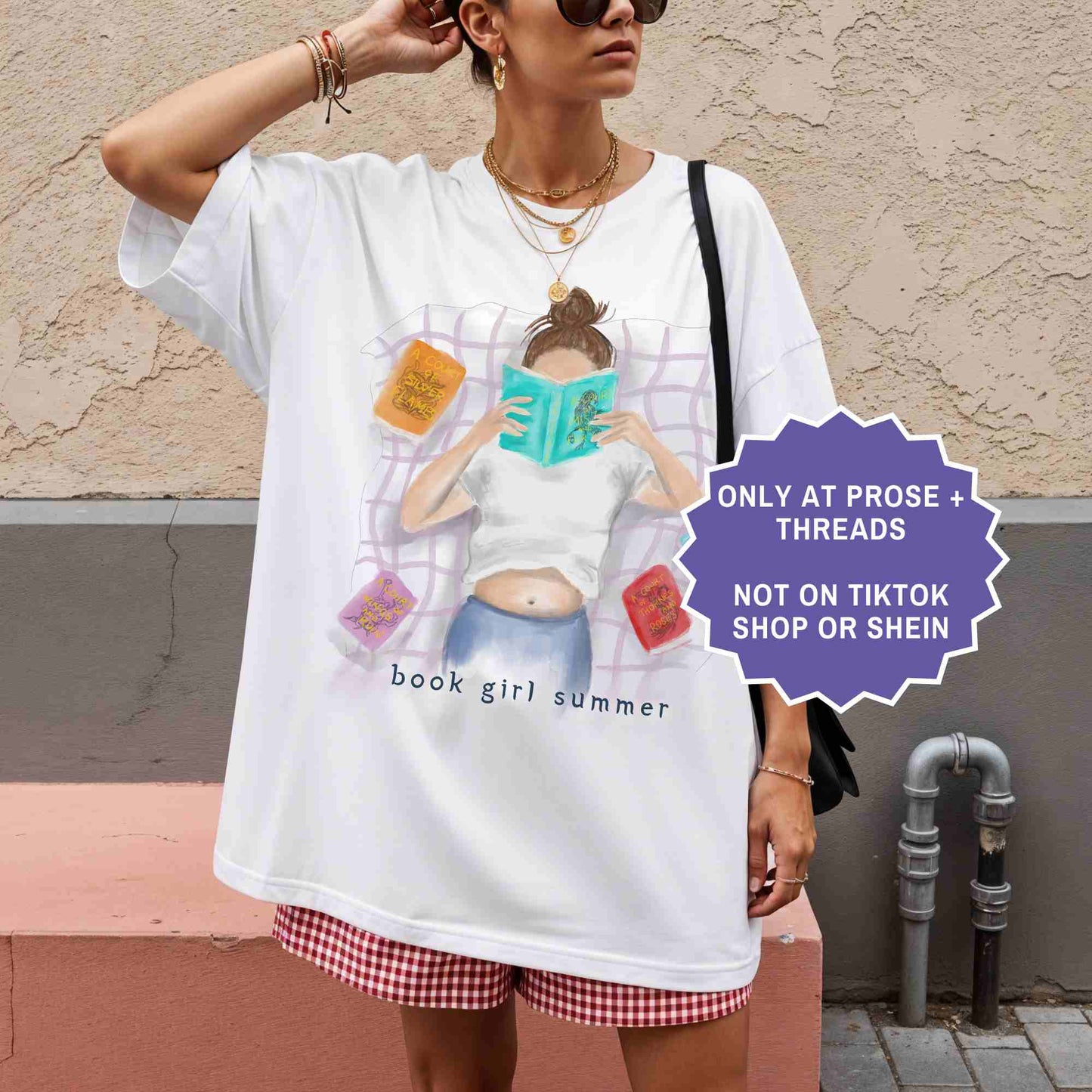 watercolor white shirt featuring a girl reading on a blanket, surrounded by ACOTAR books