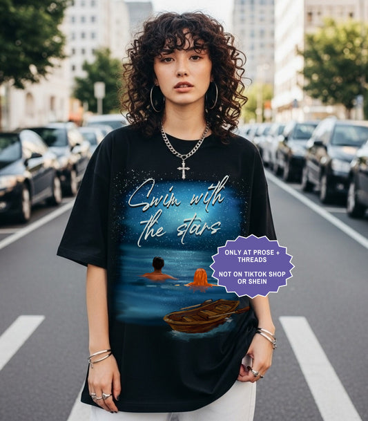 Fantasy romance shirt inspired by Metal Slinger featuring Brynn and Acker swimming beneath the stars with moonlit ocean artwork