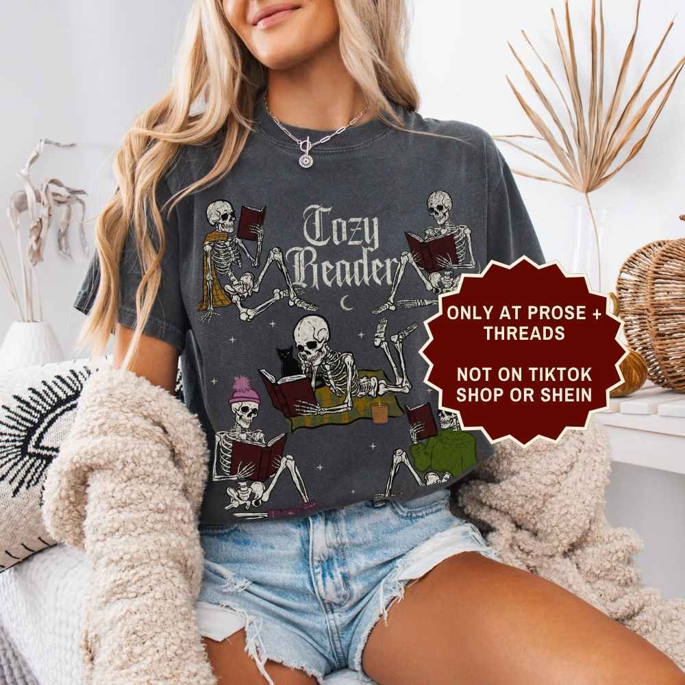 Cozy Reader Shirt featuring skeletons reading books in a vintage graphic design
