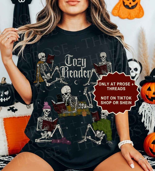 Cozy Reader Shirt featuring skeletons reading books in a vintage graphic design