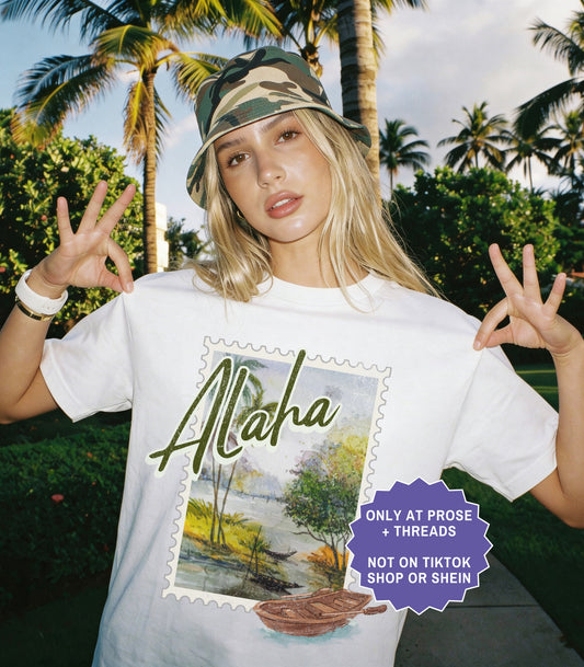 Vintage Alaha postcard fantasy romance shirt inspired by Metal Slinger by Rachel Schneider featuring scenic island artwork on oversized graphic tee